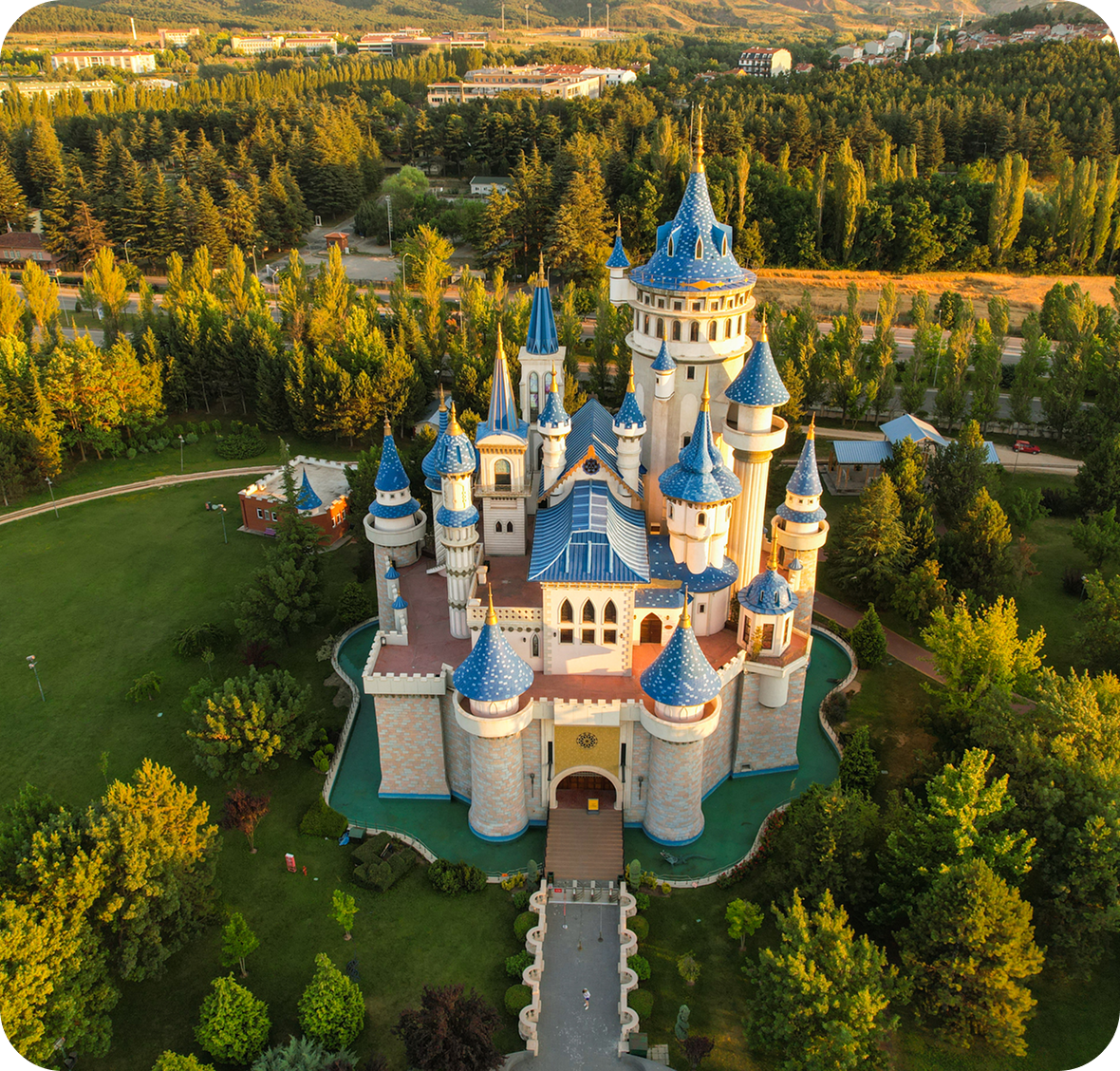 Fairytale castle with blue roofs in forest.