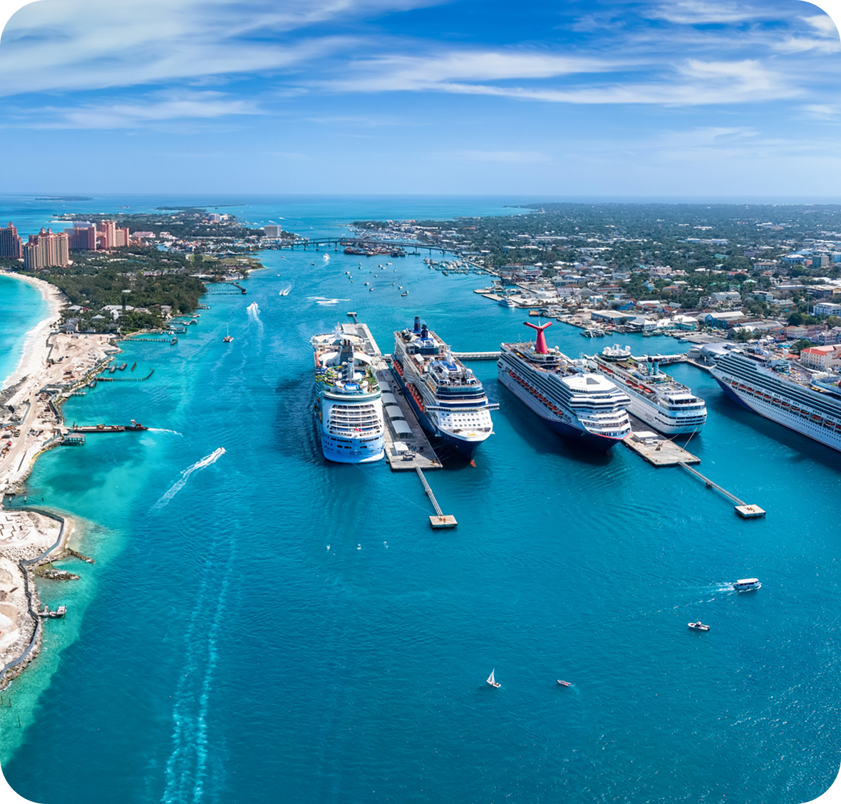 Cruise ships docked in vibrant turquoise water.