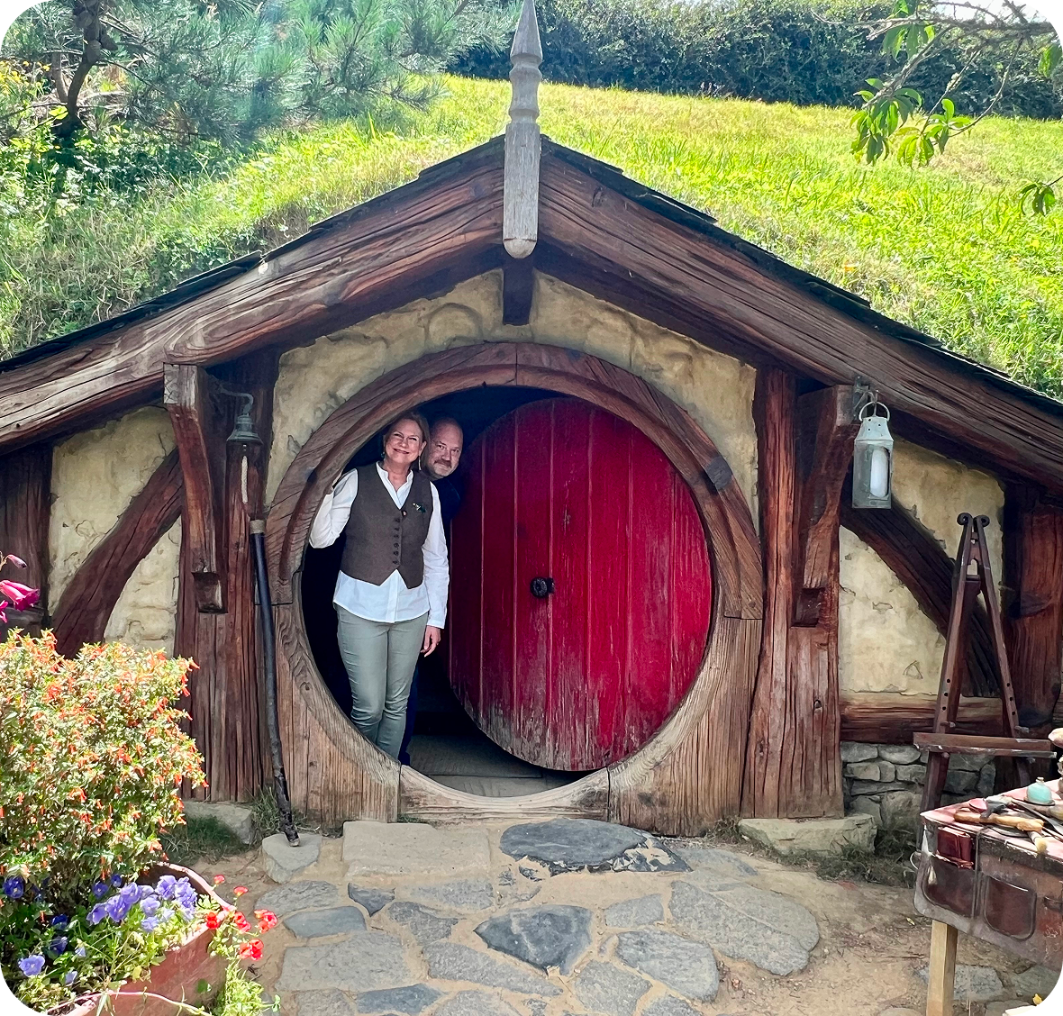 Two people standing in a Hobbit house.