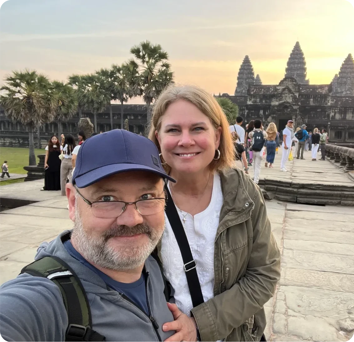Couple smiling at Angkor Wat, Cambodia sunset.