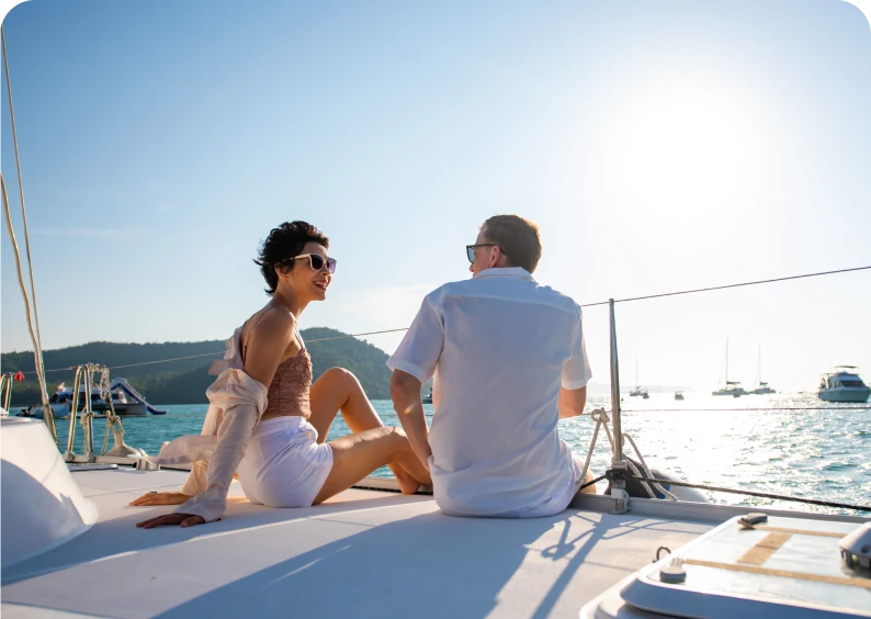 Couple relaxing on a yacht at sunset.